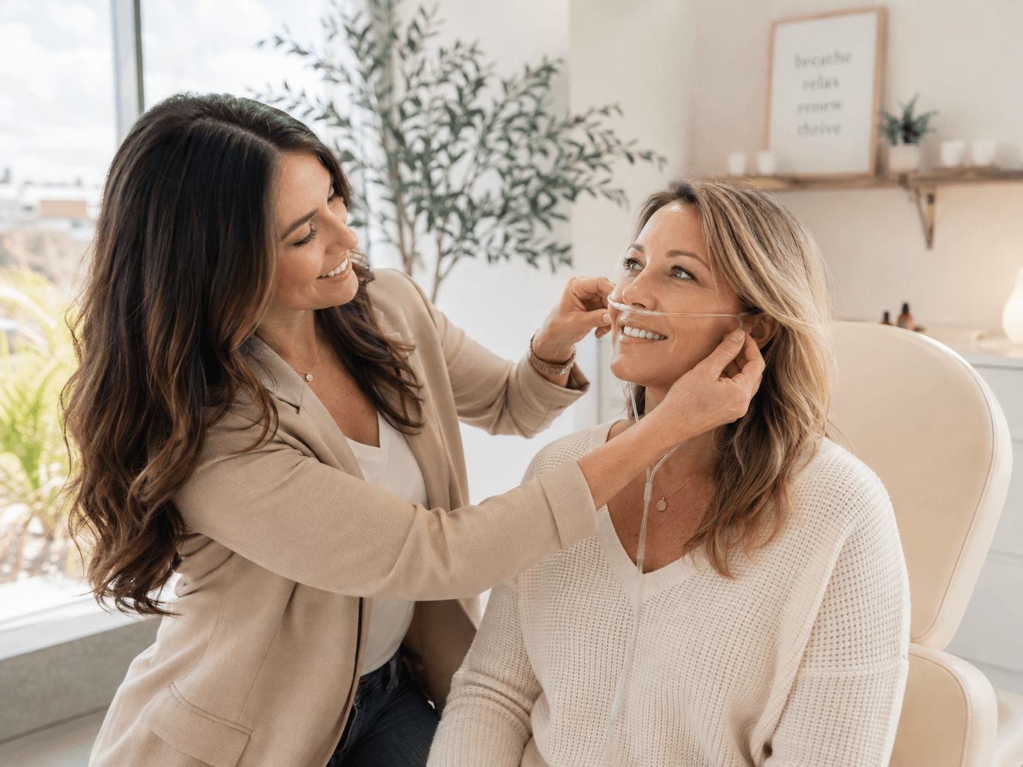A wellness practitioner showing a client how to position a nasal cannula